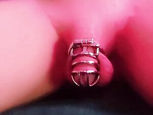 Caged Sissy riding a Dildo