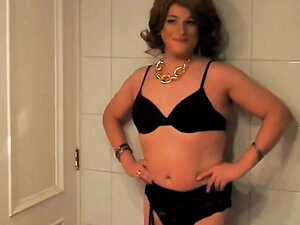Mature Chilean crossdresser Fernanda Gomez in front of the mirror on bathroom enjoying her image