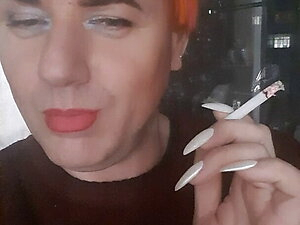 transvestite Sonyastar smokes, long nails, red hair